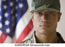 African male soldier in front of American flag