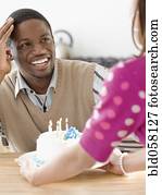 African man getting birthday cake