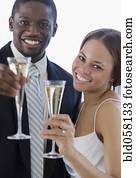 African newlyweds toasting with champagne
