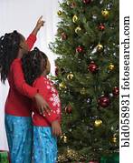 African sisters looking at Christmas tree