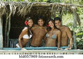 Hispanic couples in beach hut