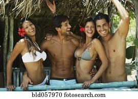 Hispanic couples in beach hut