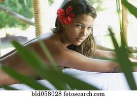 Hispanic woman laying on spa table