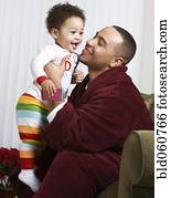 African father smiling at baby