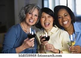Multi-ethnic women drinking wine