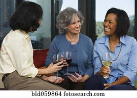 Multi-ethnic women drinking wine