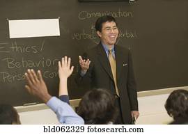 Asian teacher talking to students in classroom