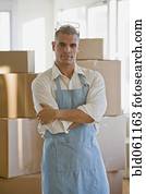 Hispanic man wearing apron and protective eyewear