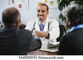 Lebanese male doctor handing patient prescription