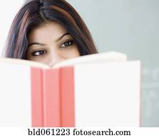 Mixed Race woman reading book