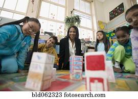 Multi-ethnic students in classroom with teacher