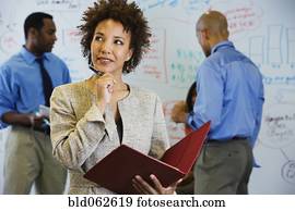 African businesswoman brainstorming with co-workers