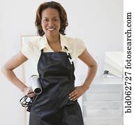 African hairdresser holding hair dryer