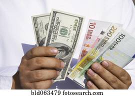 Close up of Arab man holding dollars and euros