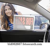 Middle Eastern woman looking at car for sale