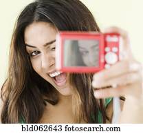 Middle Eastern woman taking self-portrait