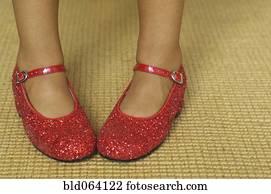 Close up of mixed race girl wearing red shoes