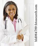 African doctor standing with medical chart