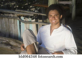 African man relaxing in beach hut