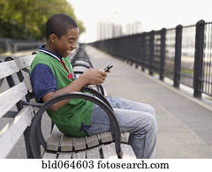 African teenager text messaging on cell phone