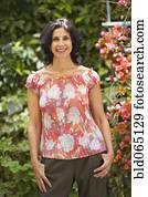 Confident Middle Eastern woman standing in garden