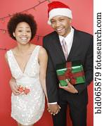 African couple holding Christmas presents