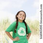 Hispanic girl on beach in t-shirt with recycling symbol