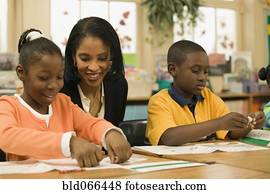 African school teacher helping students