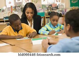 African school teacher helping students
