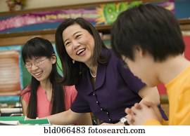 Asian school teacher laughing with students
