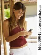 Happy woman texting on cell phone