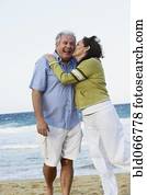 Hispanic couple kissing on beach