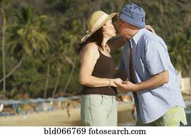 Hispanic couple kissing on beach