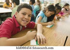 Hispanic school boy making name card