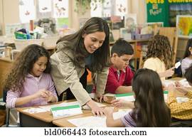 Hispanic school teacher helping students