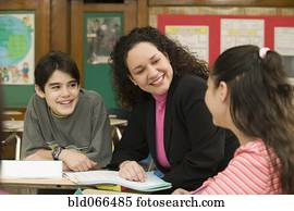 Hispanic teacher helping students