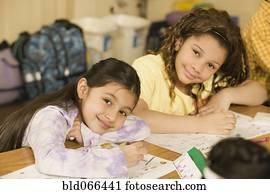 School girls writing at desks