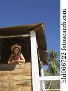 Woman in lifeguard tower at beach