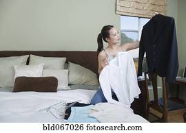 Woman packing clothes for business trip
