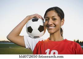 混合された 競争 女性の跳ねること サッカーボール 上に 膝 ストックイメージ Bld072653 Fotosearch
