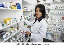 Hispanic female pharmacist shelving medication
