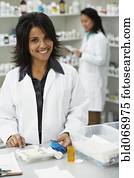 Portrait of Hispanic female pharmacist in pharmacy