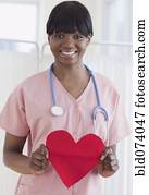 African nurse holding heart-shaped piece of paper