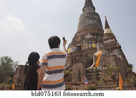 Asian couple photographing temple