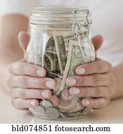 Woman holding jar with money