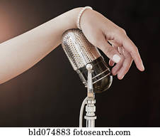 Woman's hand on retro microphone