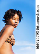 Serious African woman wearing bikini top