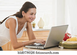 Hispanic woman using laptop