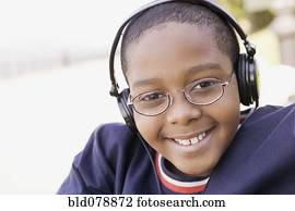 Hispanic boy listening to headphones