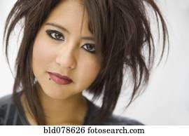 Hispanic teenage girl with wild hairstyle